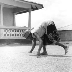 Woman Spreading Out Rice on the Ground