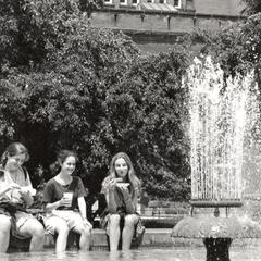 Students dip their feet into Hagenah Fountain on Library Mall