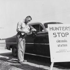 C. D. Besadny checking pheasant