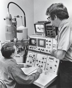 Two people working with laboratory equipment