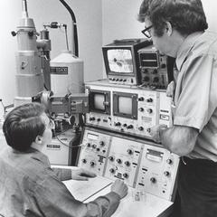 Two people working with laboratory equipment