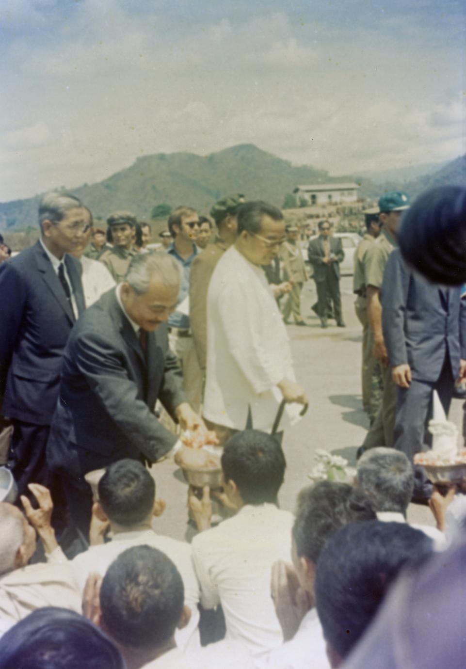 Prince Souphanouvong walks through the crowds with Phoumi Vongvichit and Prince Souvanna Phouma
