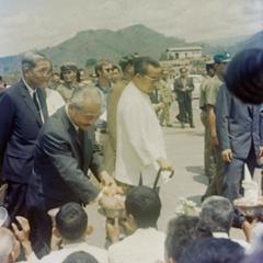 Prince Souphanouvong walks through the crowds with Phoumi Vongvichit and Prince Souvanna Phouma