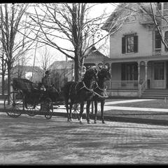 E. Bain, team and carriage, front of house