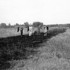 Aldo with group participating in controlled prairie burn, UW Arboretum, middle 1940s (AL 2nd from L, in white)