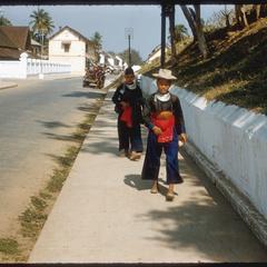 Two Hmong (Meo) men on main street.