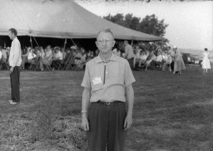 Man standing in front of tent