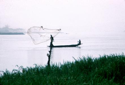 Fisherman Casting His Net from a Pirogue in the Niger River near Niamey