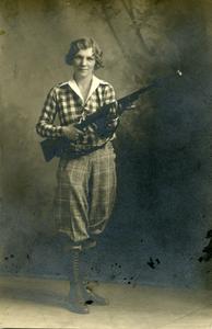 Rifle Club, Carolyn Brick holding a rifle