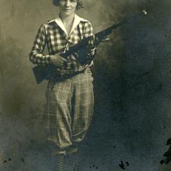 Rifle Club, Carolyn Brick holding a rifle