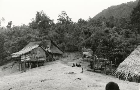 Bue Hmong (Hmong Njua) village with house and rice storage shed on the hillside in the vicinity of Muang Vang Vieng in Vientiane province