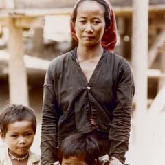 Khmu' mother with two children in a Khmu' village in Houa Khong Province