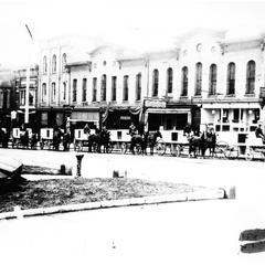Horses and wagons lined up on Milwaukee Street