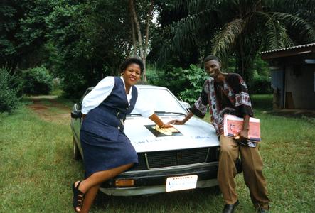 Man and woman leaning on car