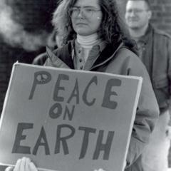 Student with "Peace on Earth" sign