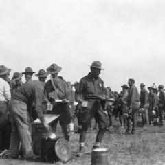 Soldiers of the US Army's 15th Infantry Regiment line up to get food from an open-air canteen.