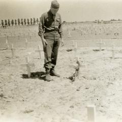 Putting flowers on Jack Holum's grave