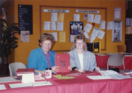 Staff members at information table during "Silverbration"