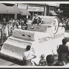 Two children sit on a float for Quincy Druggists