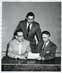 Stout Student Association - Merle Price, Ralph Iverson, and Willis Capps looking at a document