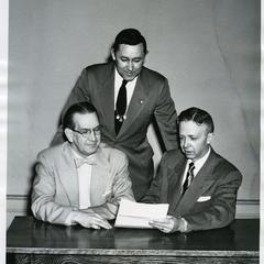 Stout Student Association - Merle Price, Ralph Iverson, and Willis Capps looking at a document