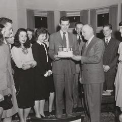 President E.B. Fred receiving cake