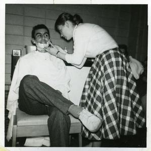 Sigma Tau Gamma - female student shaving the face of a male student