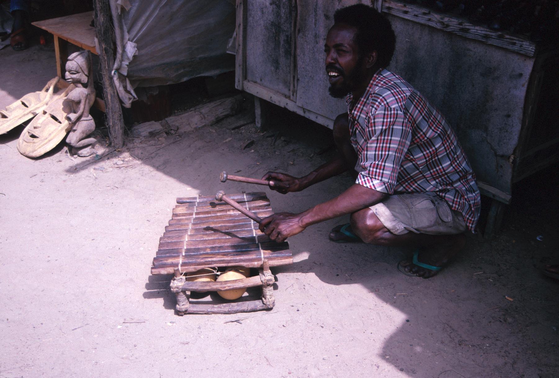 Gambian Musician with Balafon Next to Brickama Woodcarvers