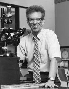 Howard Temin with microscope