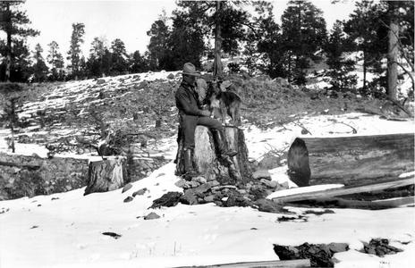 With dog "Flip" at the abandoned Irwin claim, Apache, 1910 (snowy scene)