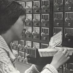 A person uses the card catalog