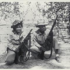 Captain and Mrs. Alfredo Soniega holding rifles, Luzon, 1945
