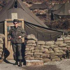 Cyril Burns in front of a tent