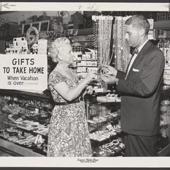 A saleswoman assists a customer in the souvenir section of a drugstore