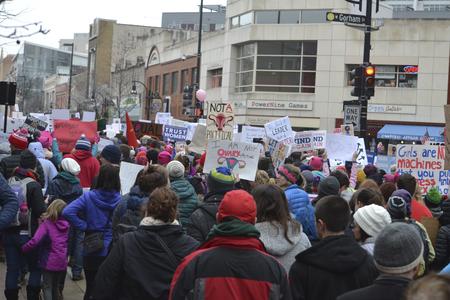 Sign-holding crowd marches up State Street