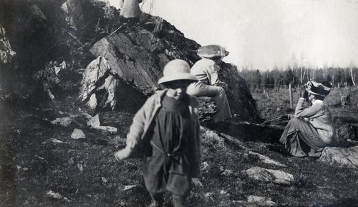 Families playing on greenstone outcrop