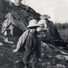 Families playing on greenstone outcrop