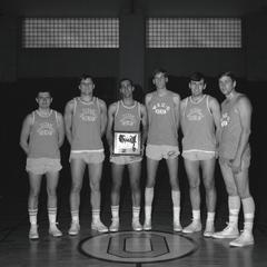 Basketball players holding trophy