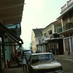 Narrow Street with Parked Cars in Urban Bissau