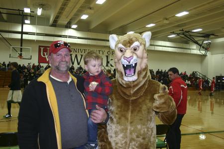 Fans pose with Corby at basketball game