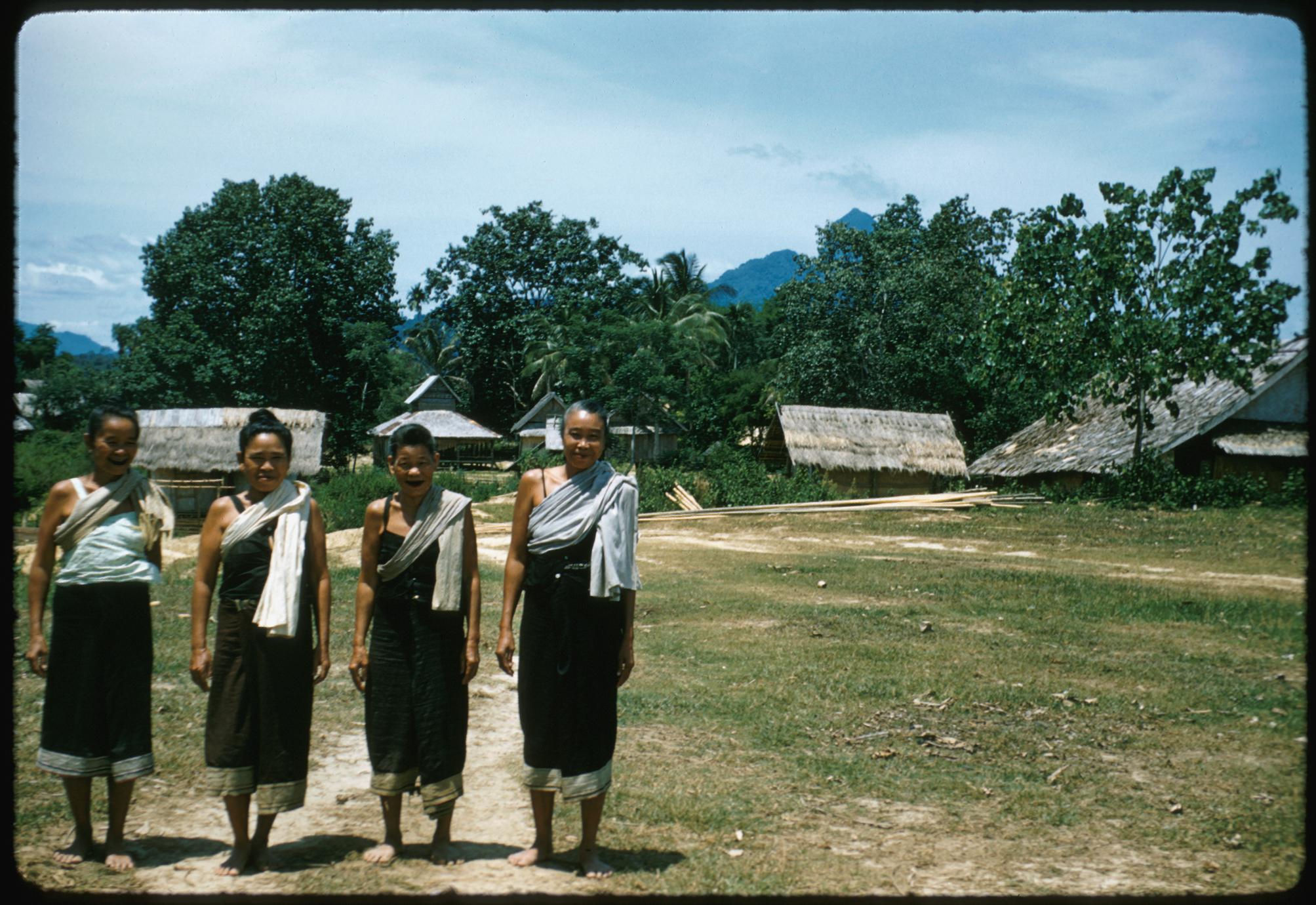 Older Lao women with sashes, barefoot, near Muang Kasy
