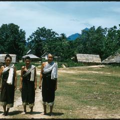 Older Lao women with sashes, barefoot, near Muang Kasy