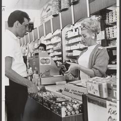A saleswoman demonstrates the features of a camera