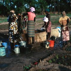 Drawing Water from Well for Watering Women's Vegetable Garden