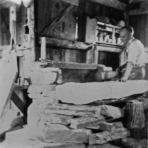 Aldo Leopold working on fireplace mantle