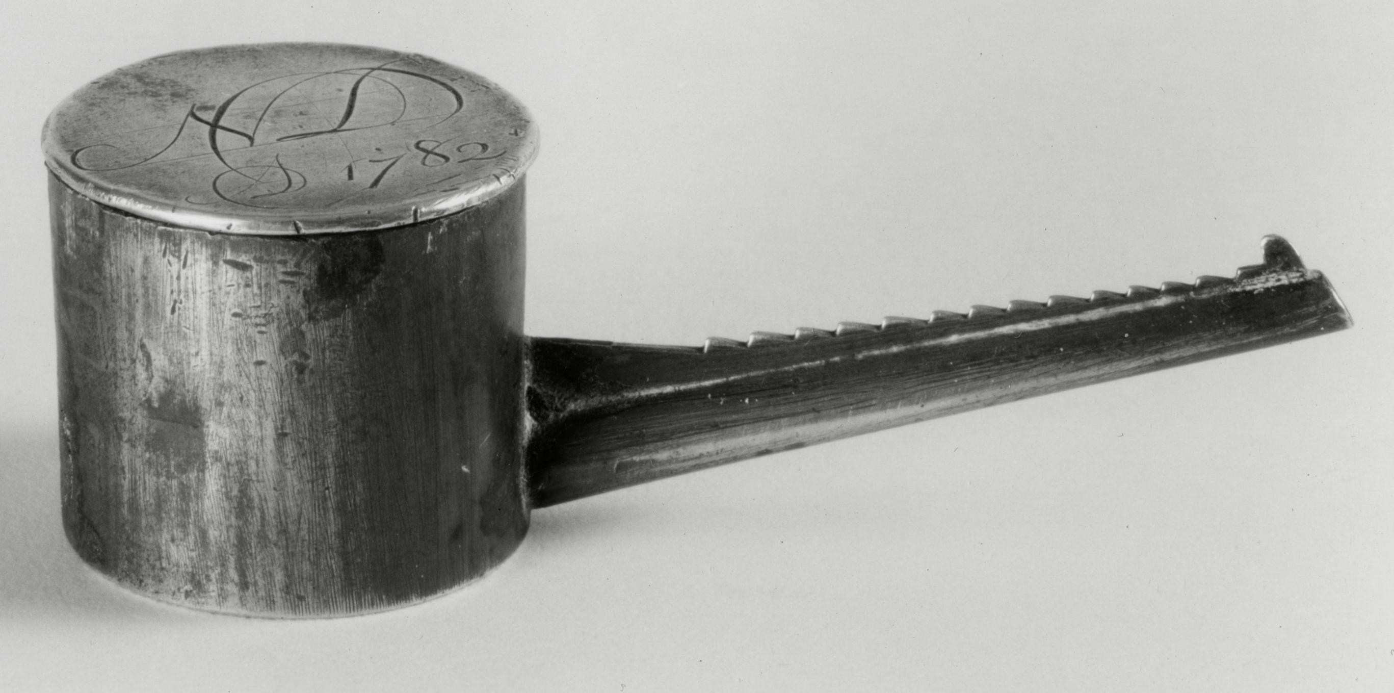 Black and white photograph of a polishing compound container.