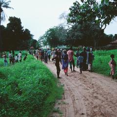 Country Road with Many Gambians Walking on It