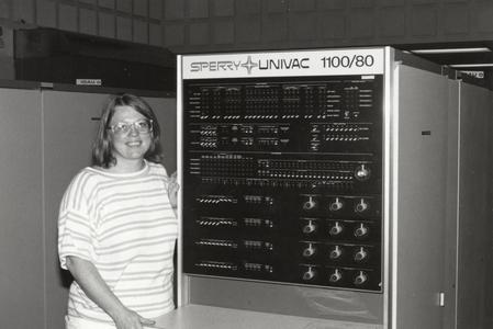 Rose Smith standing next to the UNIVAC 1100/80