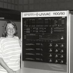 Rose Smith standing next to the UNIVAC 1100/80