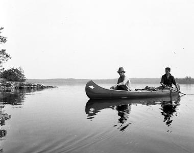 Bergere Kenney and unidentified person canoeing at Quetico